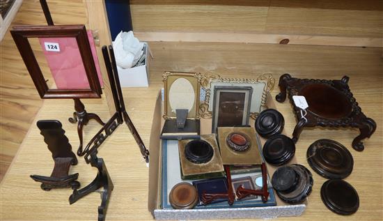 A collection of miscellaneous photograph frames and carved hardwood pot and plate stands